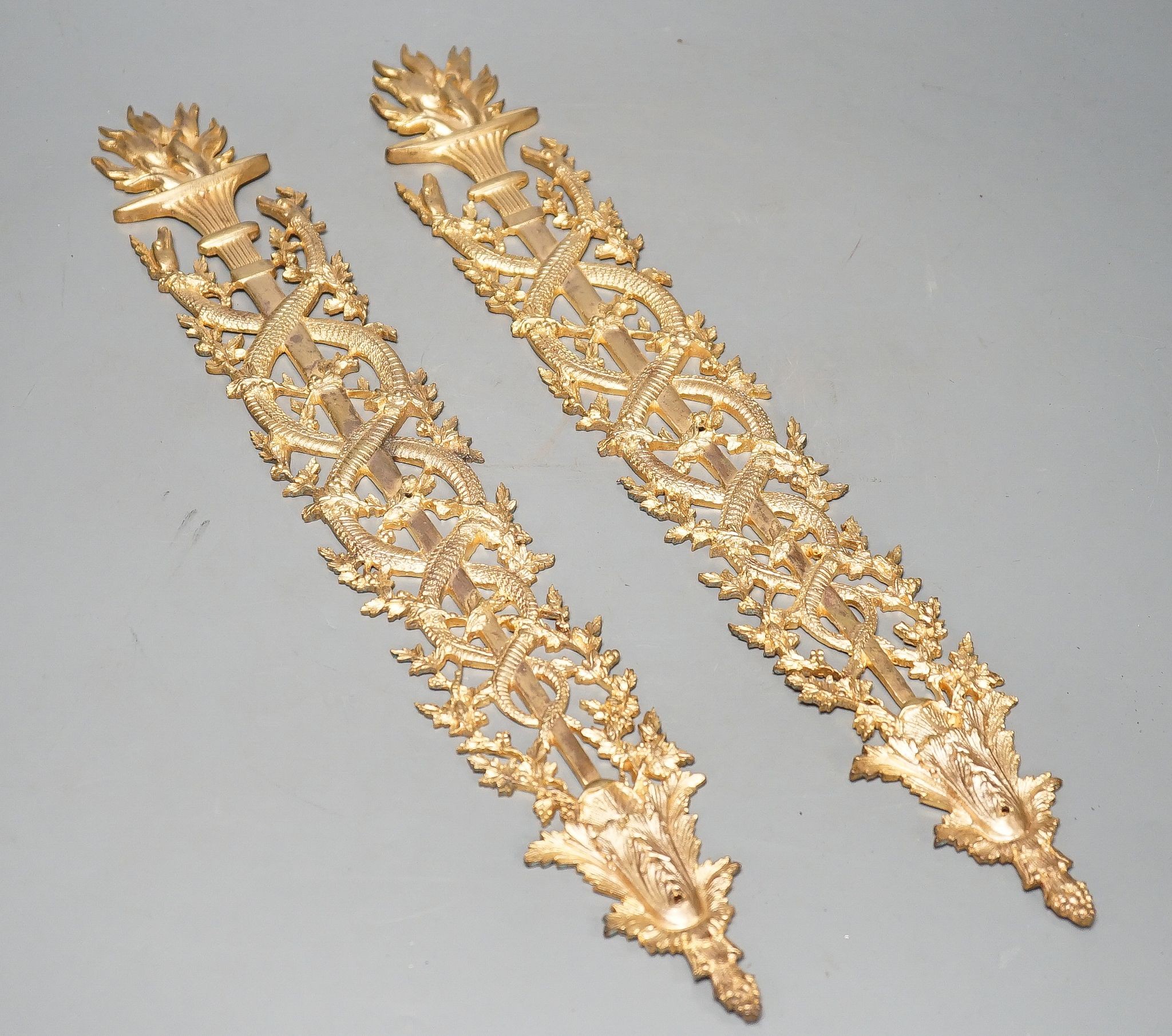 A pair of ormolu furniture mounts, circa 1900, 48cm long